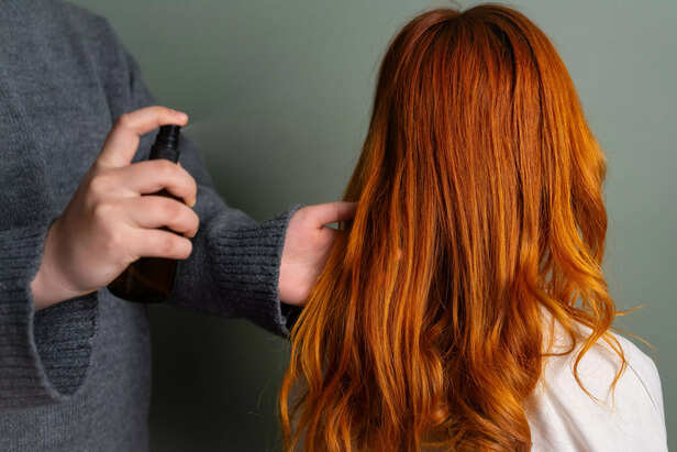 Applying hair spray on ha