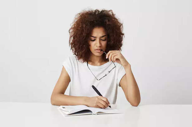 person writing their thou