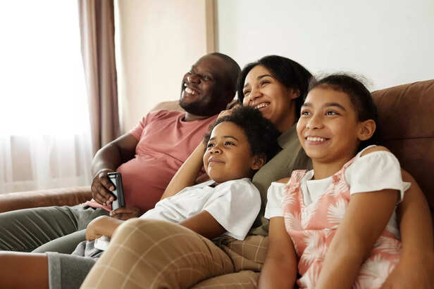 Family watching TV togeth