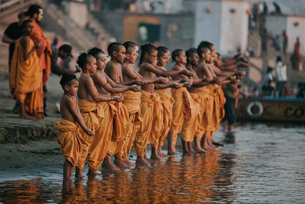 Young Monks Performing Ritual on Ganges River