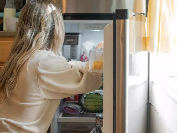 Woman organizing her fridge